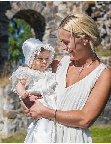 charming girl in cute christening dress